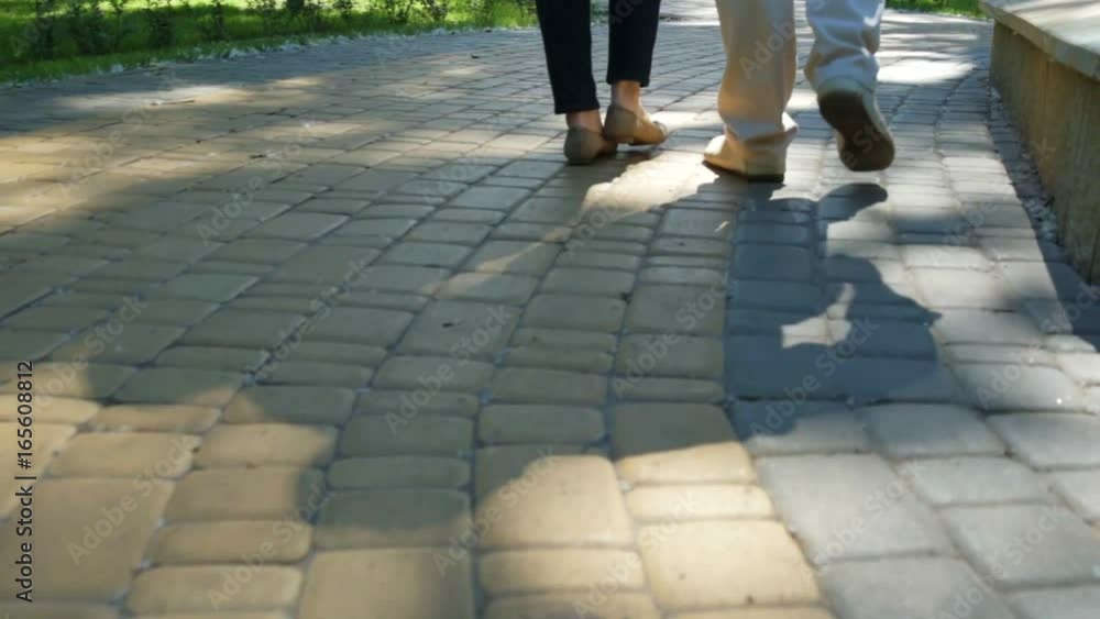 Low angle of loving couple walking in the park Low angle of loving couple walking in the park