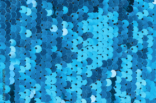 background, strewn with blue sequins, glitter sequins blue