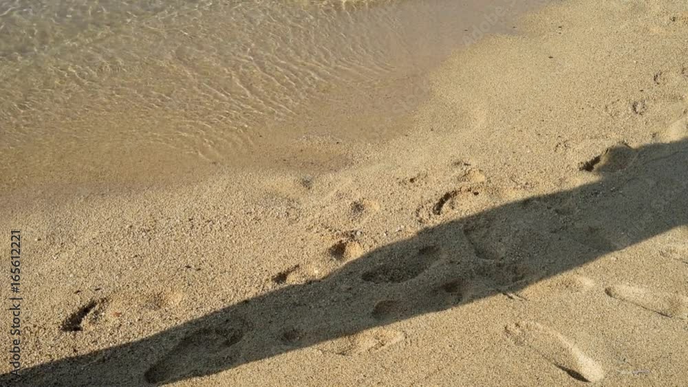 Woman walking on the sandy beach. Close-up. Woman walking on the sandy beach. Close-up.