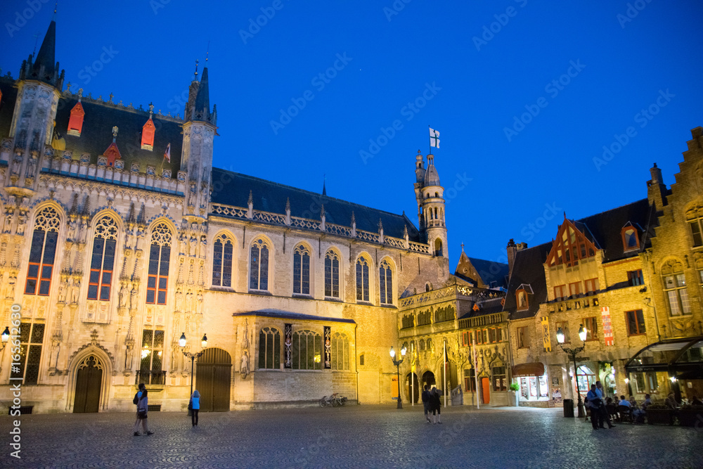 Square in Bruges city center at evening, Belgium