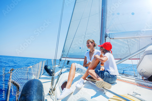 Brother and sister on board of sailing yacht on summer cruise. Travel adventure, yachting with child on family vacation.