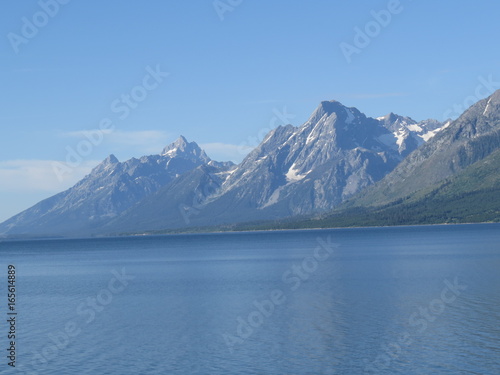 Snow covered mountains behind a crisp lake