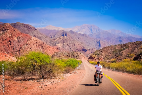 Man cycling on the empty road to Cafayate