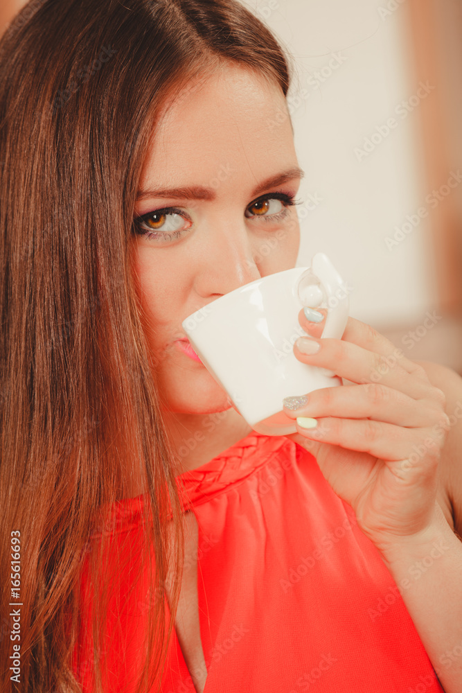 Pretty woman drinking tea or coffee at home. Pretty woman drinking tea or coffee at home.