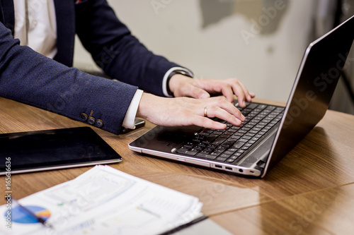 Businessman Working Laptop Connecting Networking Concept,Businessman working with documents on office desk.Business concept.Close up
