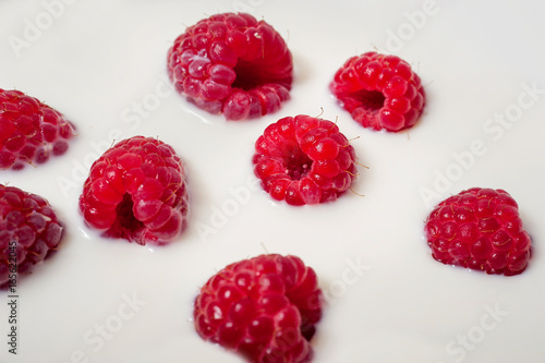 macro of fresh raspberry in milk desert