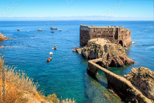 Fort São João Baptista of Berlengas, with anchored boats, seen from Berlenga island, in Portugal, with Peniche coast at sight. photo