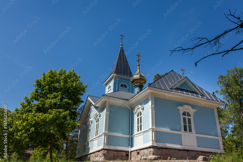 Blue church surrounded by forest on a sunny day Blue church surrounded by forest on a sunny day