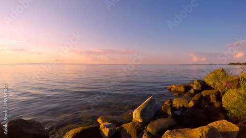 Rocky shore and clear water in De La Salle Park, Lake Simcoe, Ontario cottage country at dusk in summer