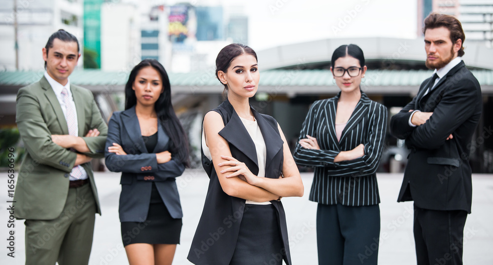 Businesspeople standing with team at city. People looking for business project with team. Business people with leader concept. Businesspeople standing with team at city. People looking for business project with team. Business people with leader concept.