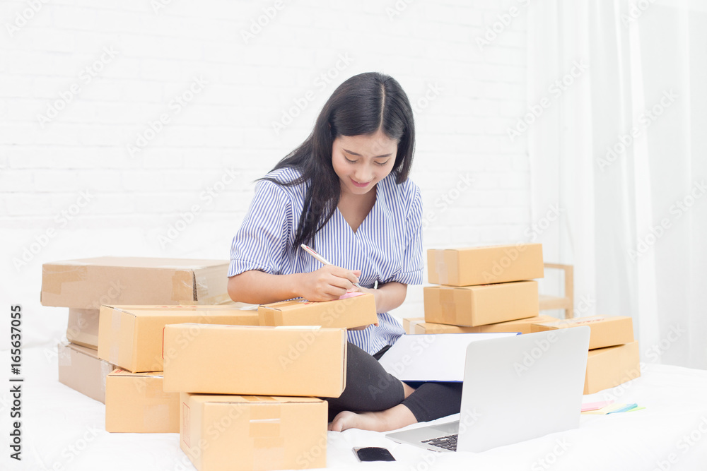 Young asian woman business owner work and white down address for deliver at home, woman business owner concept, 20-25 year old. Young asian woman business owner work and white down address for deliver at home, woman business owner concept, 20-25 year old.