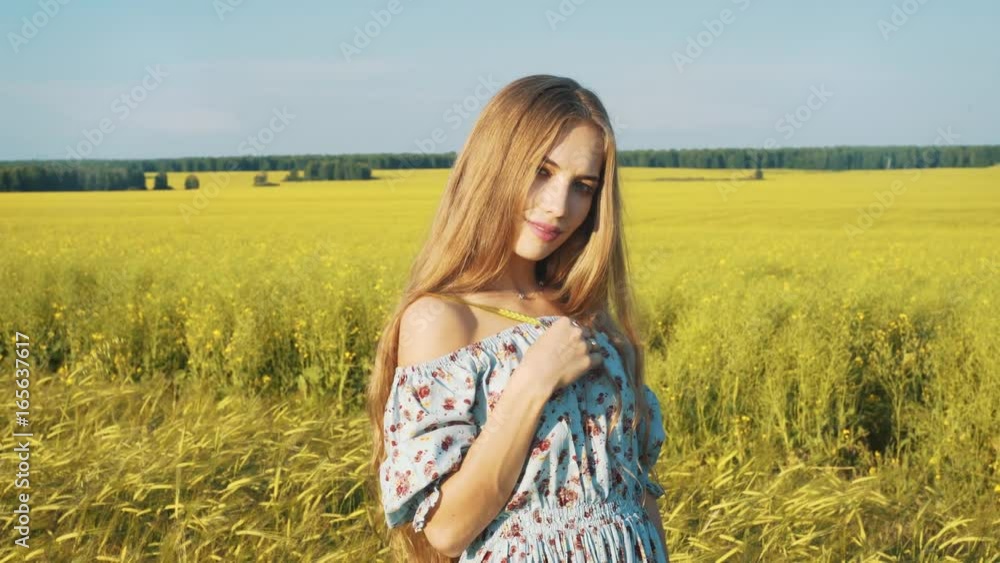 Beauty Romantic Girl Outdoors. Beautiful Teenage Model girl Dressed in Casual Short Dress on the Field in Sun Light. Blowing Long Hair. Autumn. Glow Sun, Sunshine. Backlit. Beauty Romantic Girl Outdoors. Beautiful Teenage Model girl Dressed in Casual Short Dress on the Field in Sun Light. Blowing Long Hair. Autumn. Glow Sun, Sunshine. Backlit.