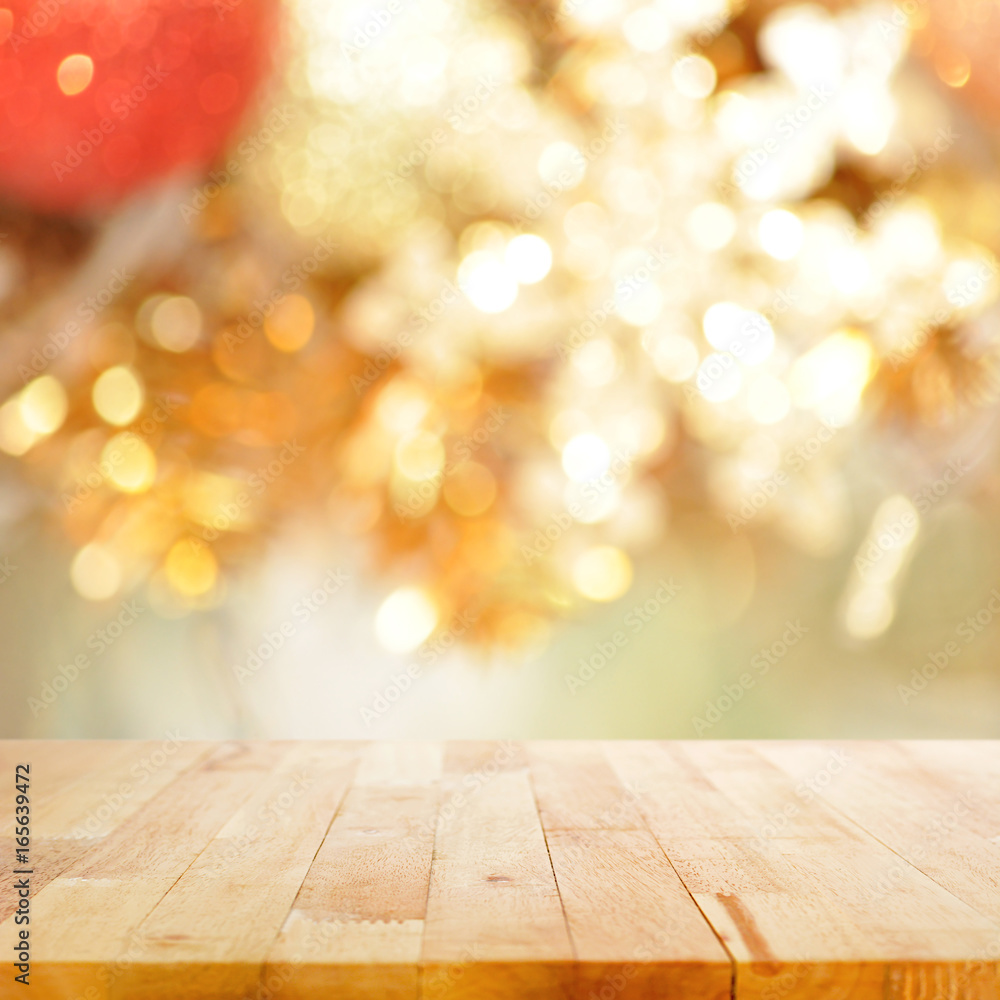 Wood table top on blurry gold background - festive background concept Wood table top on blurry gold background - festive background concept
