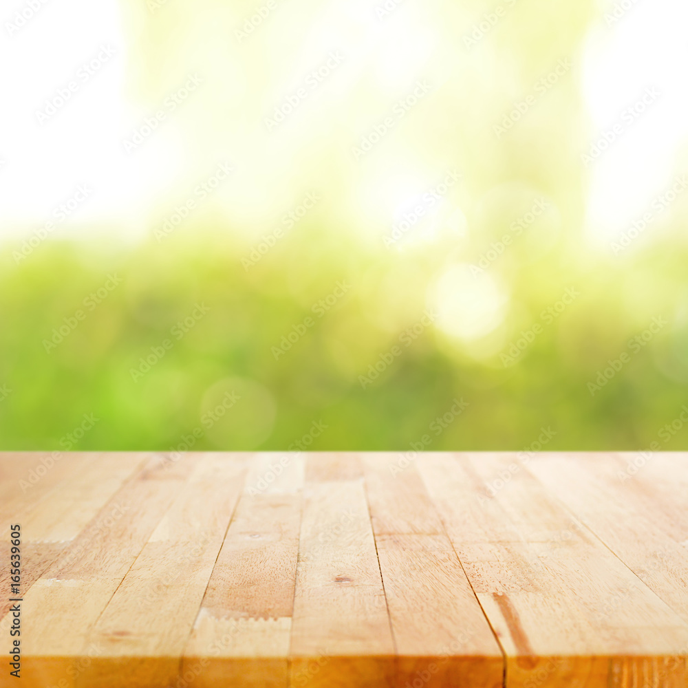 Wood table top on blurry green abstract background Wood table top on blurry green abstract background