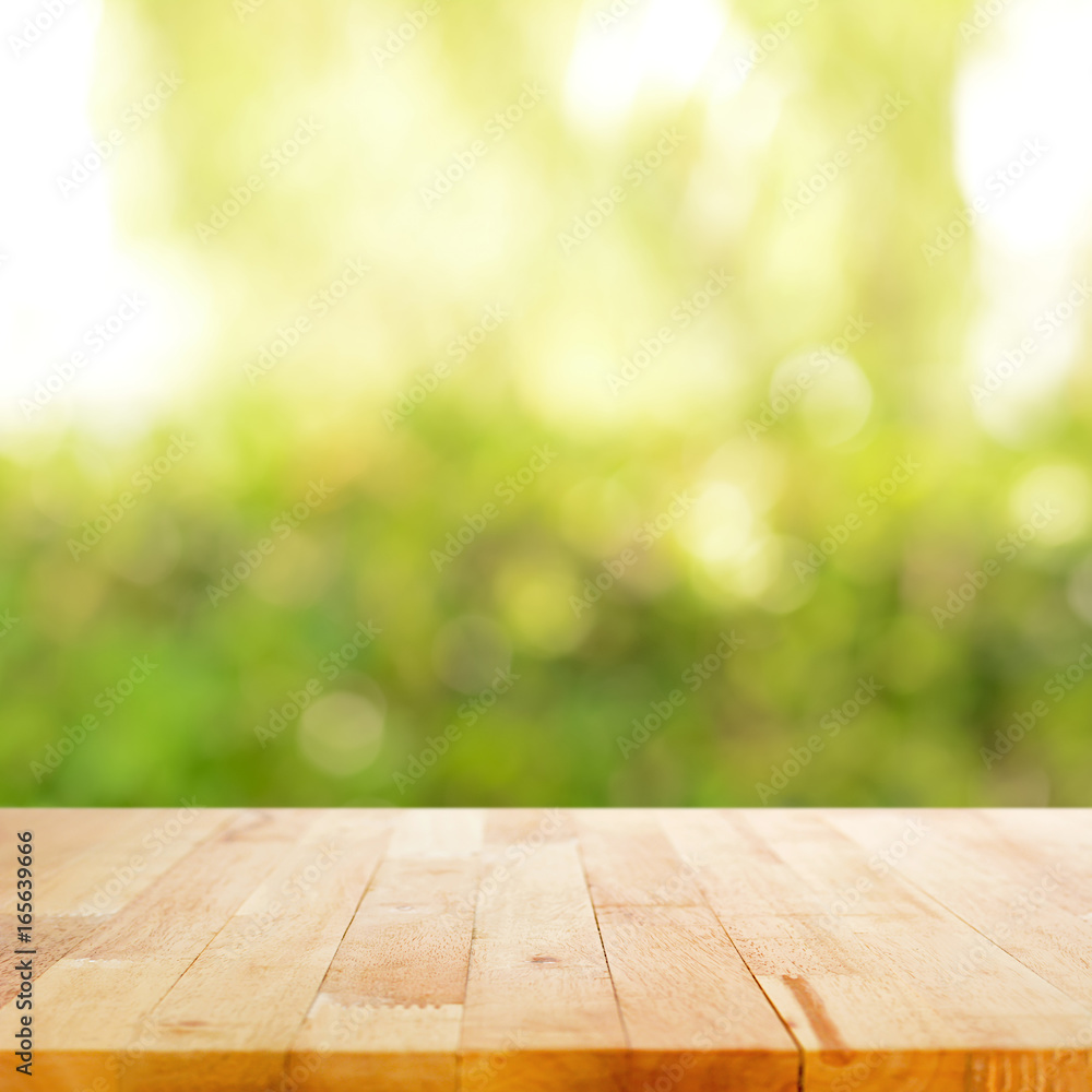 Wood table top on blurry green abstract background Wood table top on blurry green abstract background
