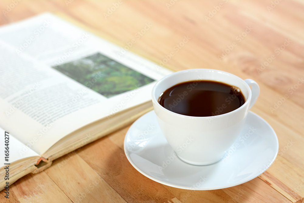 Coffee cup with book on wood table Coffee cup with book on wood table