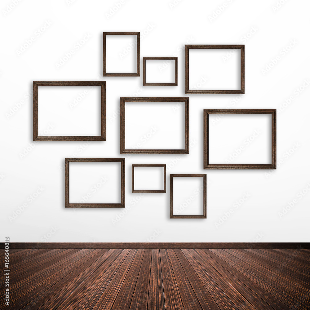 Wooden photo frames on white wall inside the room Wooden photo frames on white wall inside the room