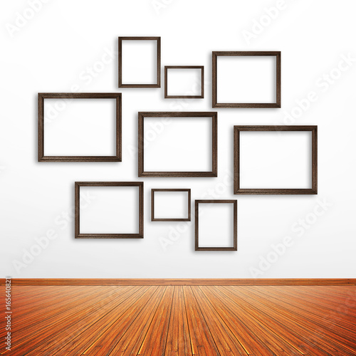 Wooden photo frames on white wall inside the room © Atstock Productions