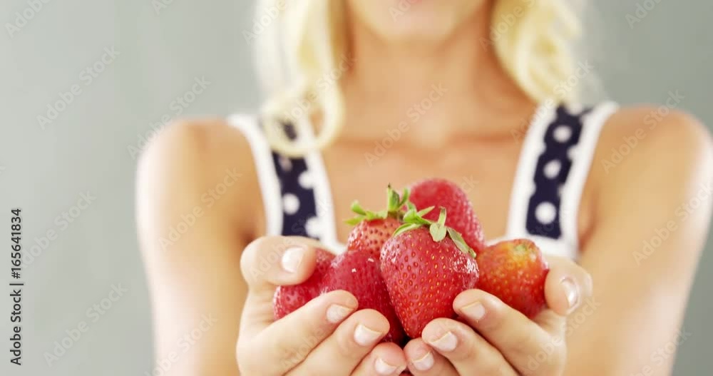 Close-up of woman holding strawberries Close-up of woman holding strawberries
