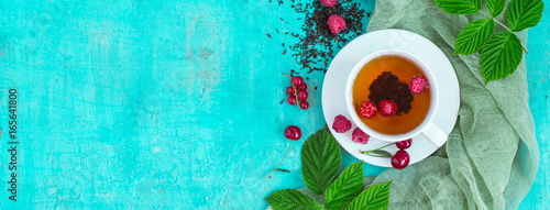 Freshly brewed tea with summer ripe berries. Top view, Banner format