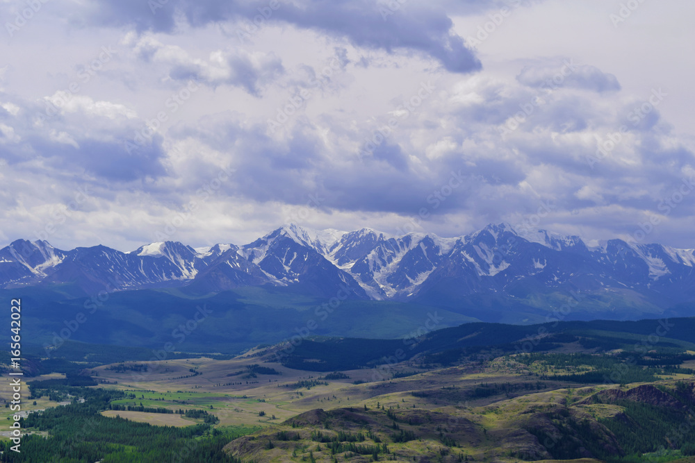 View of white peaks of North-Chuyski ridge and Kurai steppe in Altai mountains. Altay Republic, Siberia, Russia.