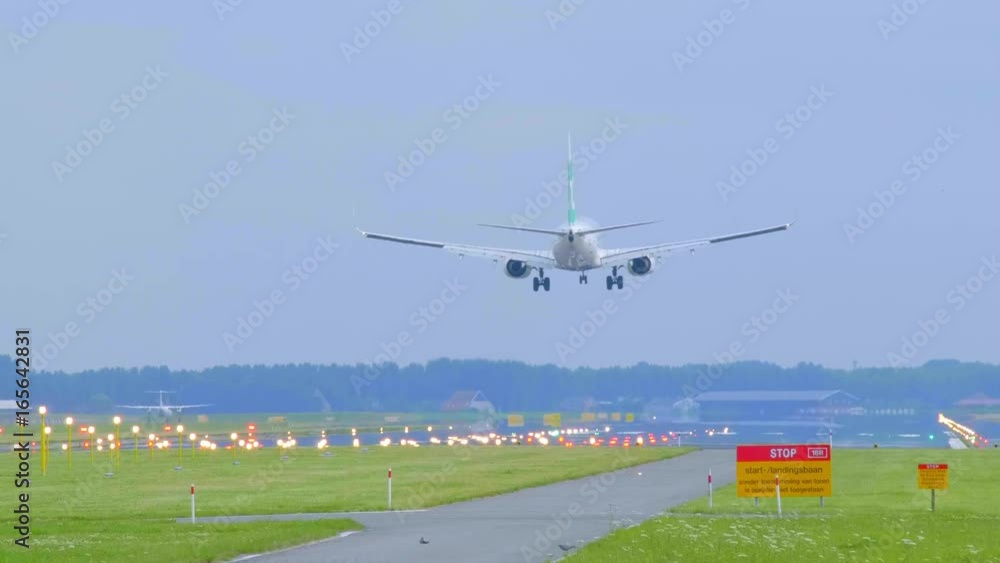 Small airplane landing on the runway of an airport Small airplane landing on the runway of an airport