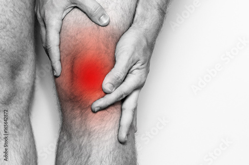 Canvas Print Acute pain in a knee joint, close-up