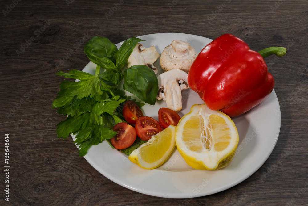 Parsley, lemon, pepper, champignons on a plate