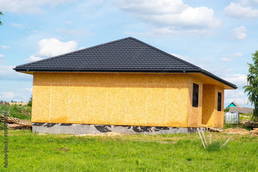 frame country house lined with osb plates with brown roof made of metal frame country house lined with osb plates with brown roof made of metal