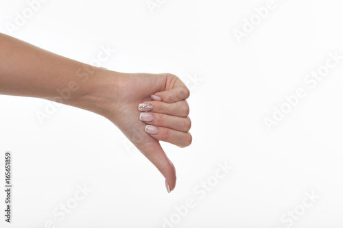 Woman hand with thumb down on a white isolated background