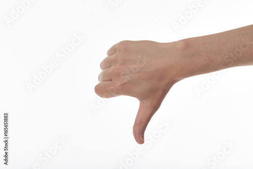 Mans hand showing thumb down in isolation. Showing a thumb down gesture. Isolated on white background. Dislike