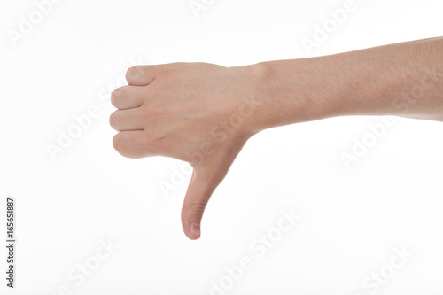 Mans hand showing thumb down in isolation. Showing a thumb down gesture. Isolated on white background. Dislike