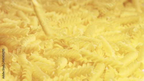 Fusilli Doppia Rigatura raw pasta falling on a heap photo
