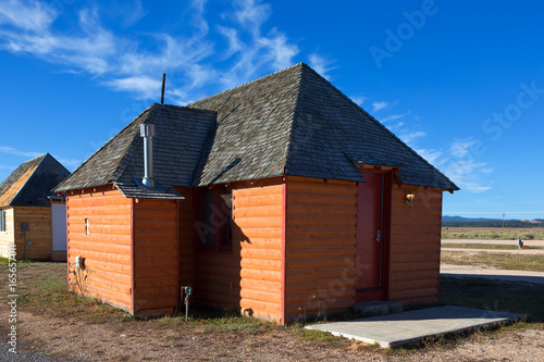 Exterior view of wooden log cabin with blue sky