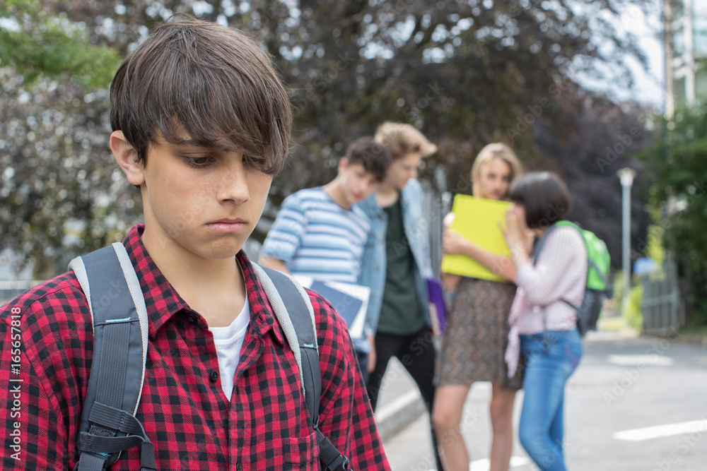 Unhappy Boy Being Gossiped About By School Friends Unhappy Boy Being Gossiped About By School Friends