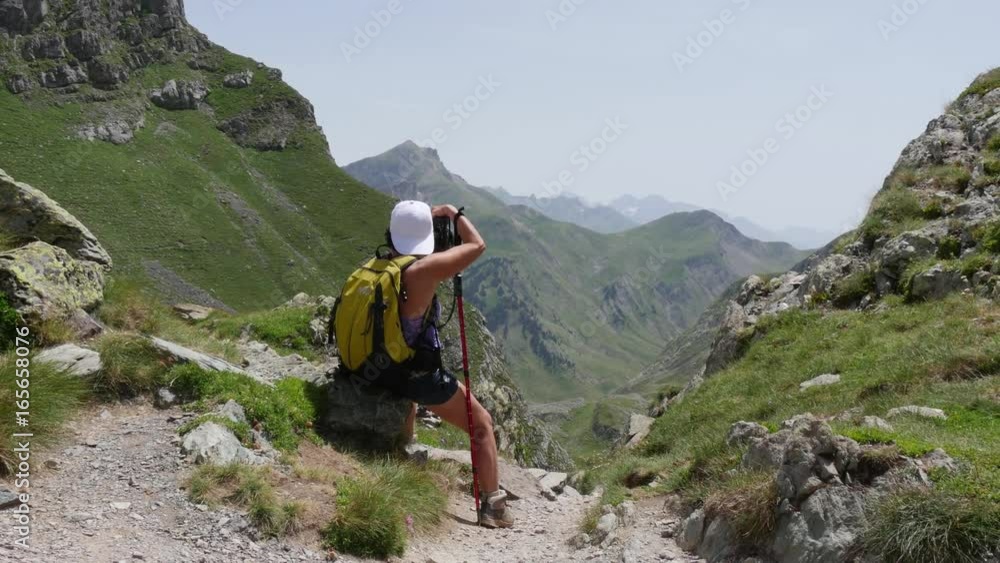 hiking woman taking pictures of the mountain hiking woman taking pictures of the mountain