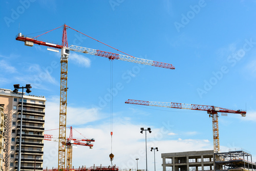 Four tower cranes on a construction site