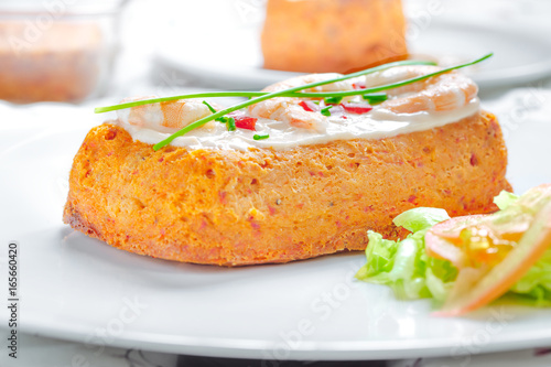 Delicious spanish Fish cake. Hake cake with tuna, tomato, shrimps, chive and salad cream. photo