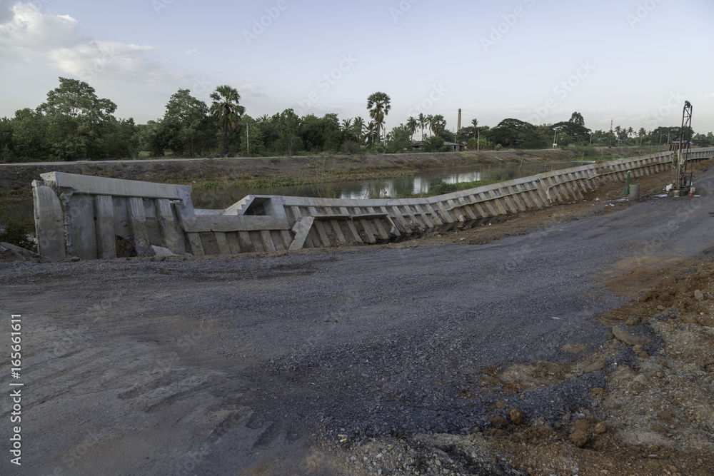 the picture of road destroyed and next to canal in Thailand  .