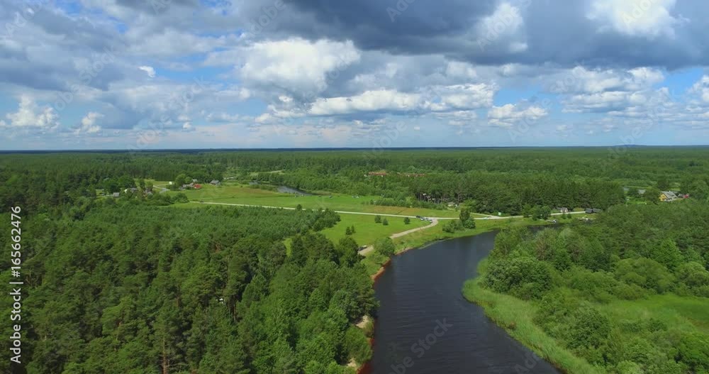Aerial view of blue river among the forest and fields. Aerial footage. Aerial view of blue river among the forest and fields. Aerial footage.