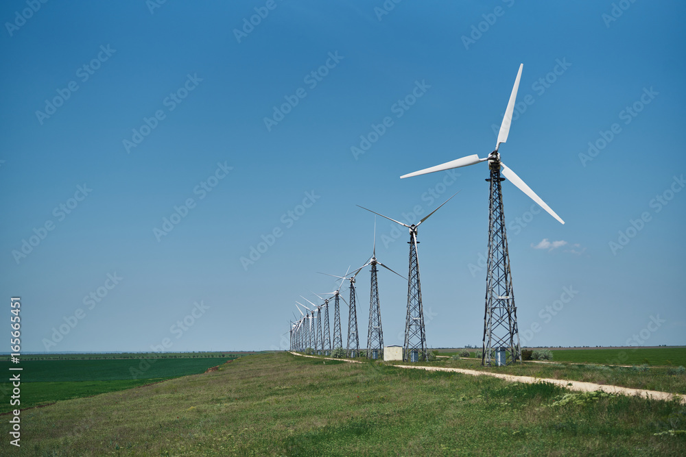 Windmills in the field, summer, sun, grass, sky Windmills in the field, summer, sun, grass, sky
