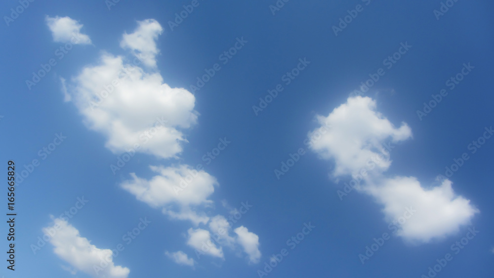 Naklejka premium Cumulus white clouds on the left of bright blue sky