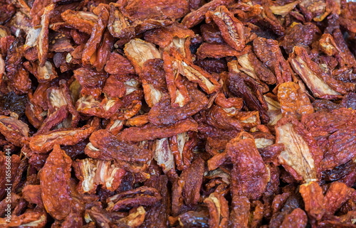 Heap of dried tomatoes sold at  local city market. Provence. France © vadiml
