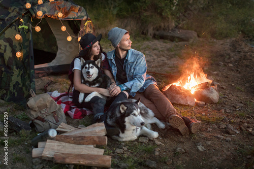 Couple with dogs in tent on nature © demphoto