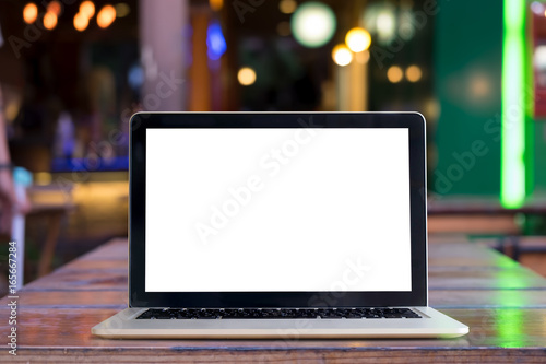 Mock up Laptop marble top table and blurred cafe background. Blank screen for graphis display montage.