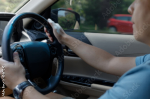 blur image, man hand holding control steering wheel drive car