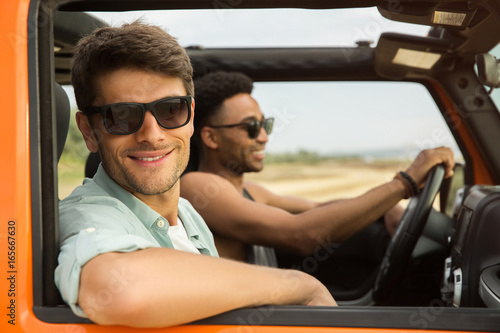 Smiling attractive man on a road trip with his friend