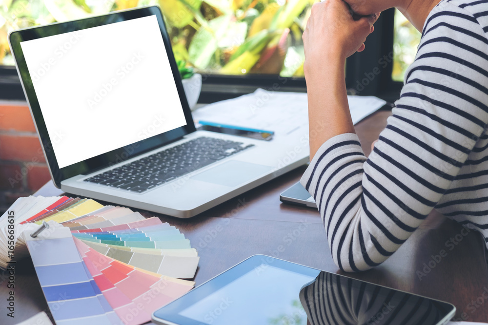 Fototapeta premium Creative creativity graphic designer working with graphics tablet,laptop and smart phone, colour chart at workplace on wooden desk , colour ideas style concept