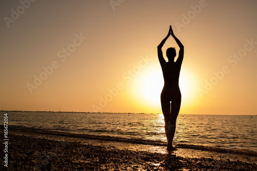 Wallpaper Mural Silhouette of Young Woman on a ocean shore Torontodigital.ca