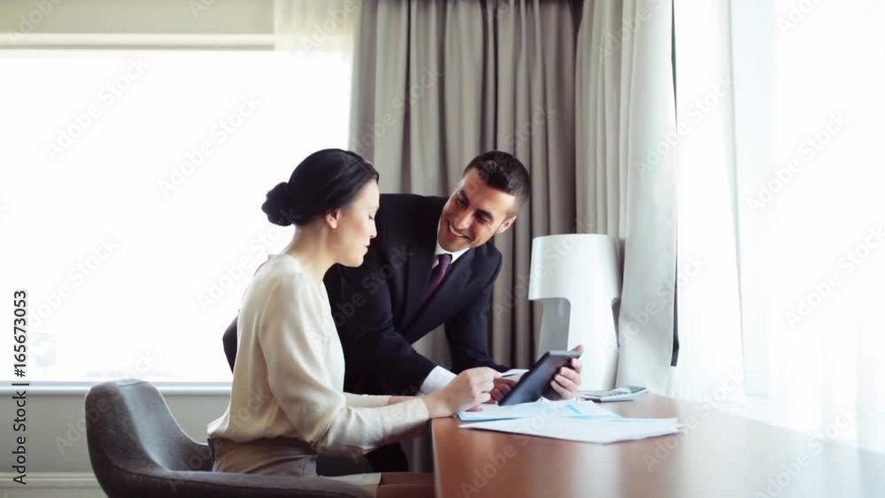business team with papers and tablet pc at hotel business team with papers and tablet pc at hotel